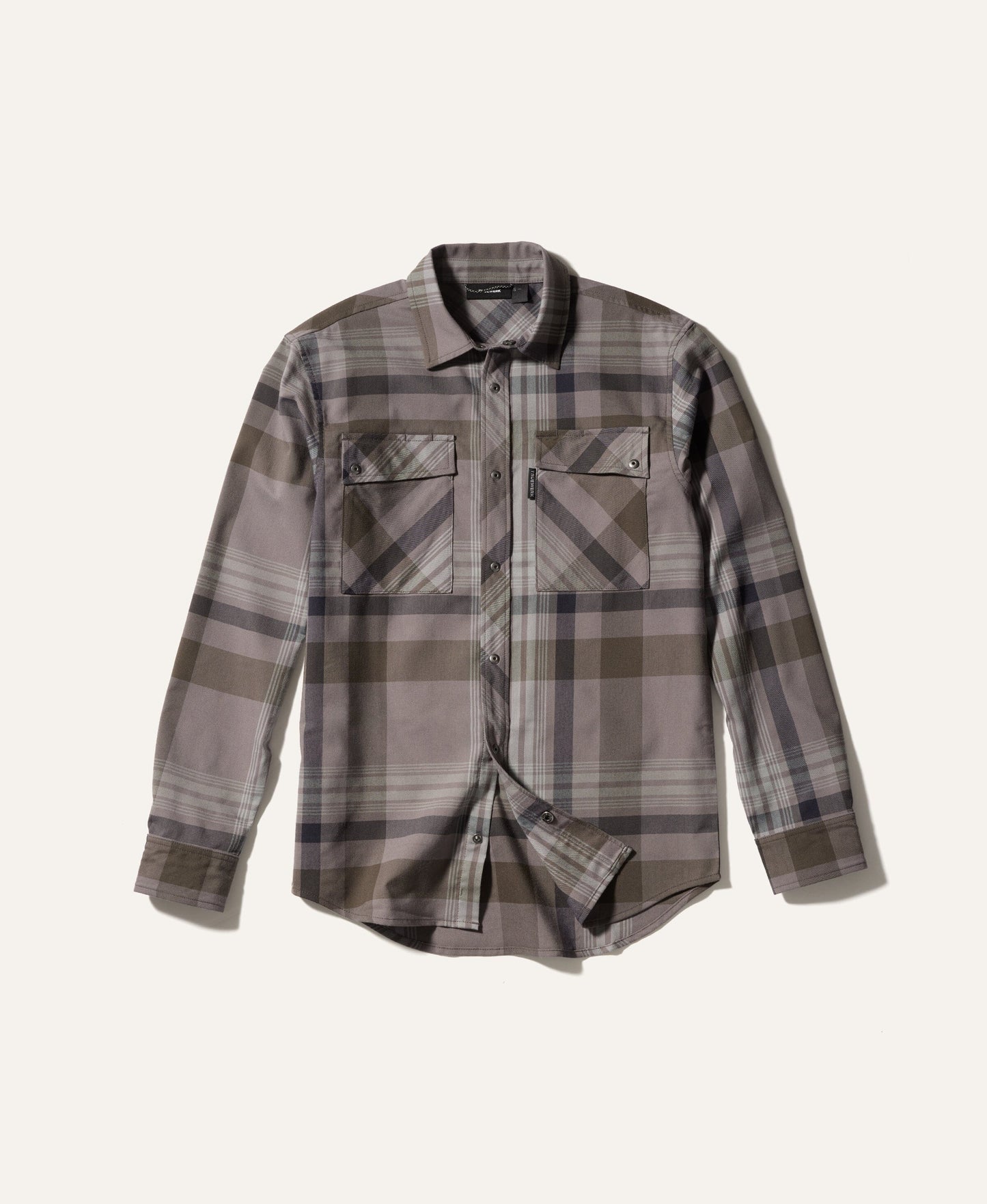 Plaid shirt with a neutral color palette on a light beige background